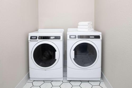 two washing machines sitting next to each other in a room at Best Western Plus All Suites Inn in Santa Cruz