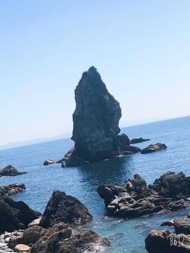 a large rock in the middle of the ocean at Kizuna House Yuzuriha in Minamiawaji