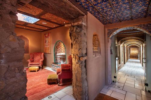 a living room with a stone wall at The Inn of Five Graces in Santa Fe