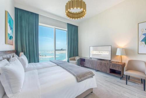 a bedroom with a large bed and a large window at GLOBALSTAY Palm View in Dubai