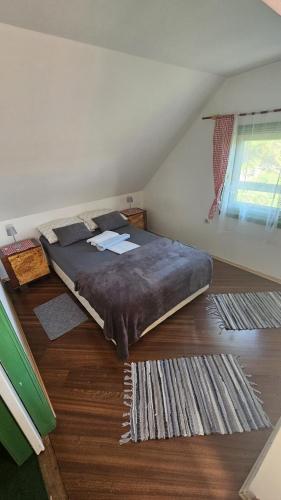 a bedroom with a large bed on the floor at Jurina Hiža in Beletinec