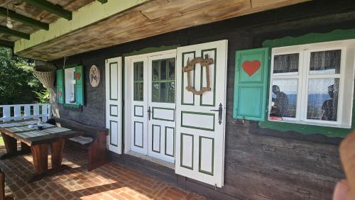 a house with a door and a table on a patio at Jurina Hiža in Beletinec