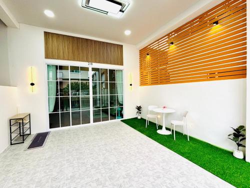 a room with a table and chairs in a building at Mali house Hatyai in Hat Yai