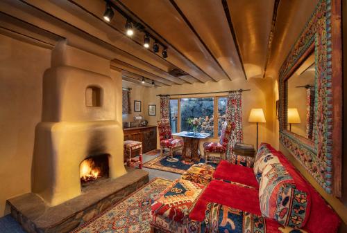 a living room with a fireplace and a couch at The Inn of Five Graces in Santa Fe