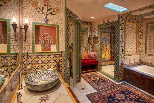 a bathroom with a tub and a sink and a bath tub at The Inn of Five Graces in Santa Fe