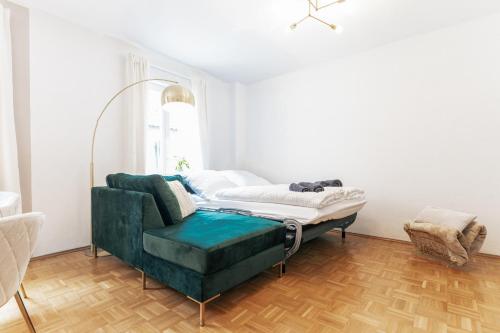 a bed in a room with a green couch at JAMA - Designapartment im Herzen der Stadt in Schweinfurt