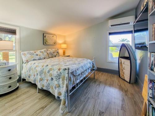 a bedroom with a bed and a dresser and a window at Cozy Coastal Retreat in Port Lavaca
