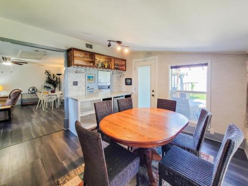 a kitchen and dining room with a wooden table and chairs at Cozy Coastal Retreat in Port Lavaca