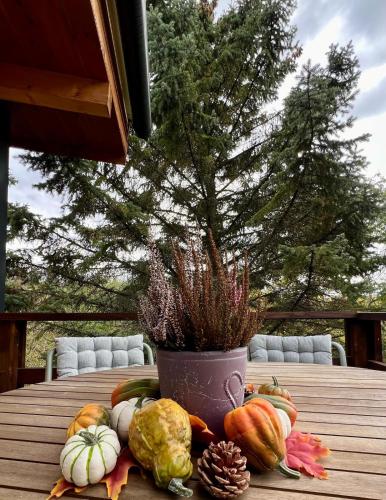 a table with a vase filled with vegetables on it at Zebikuckó vendégház in Zebegény