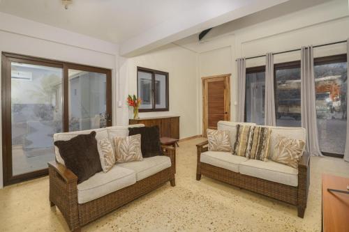 a living room with two couches and a window at Casa de Wilson - 5 Bedroom Beachfront Villa in Maya Beach