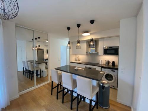 une cuisine et une salle à manger avec une table et des chaises dans l'établissement Harmonieux Yourhosthelper, à Chaville