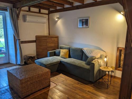 a living room with a couch and a table at Clos de Gigondas Countryside house 10 mins from CHU and Limoges center in Isle
