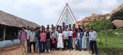a group of people posing for a picture in front of a pyramid at Murali Guesthouse Hampi in Hampi