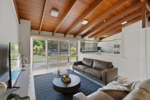 a living room with a couch and a table at Charming 4BR House with Parking near Sunnybank in Brisbane