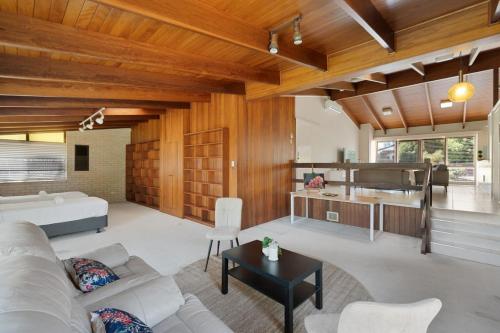 a living room with a couch and a table at Charming 4BR House with Parking near Sunnybank in Brisbane