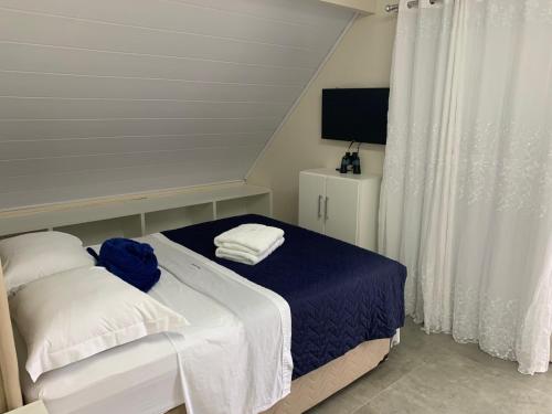 Ένα ή περισσότερα κρεβάτια σε δωμάτιο στο Pinheira Beach Residence