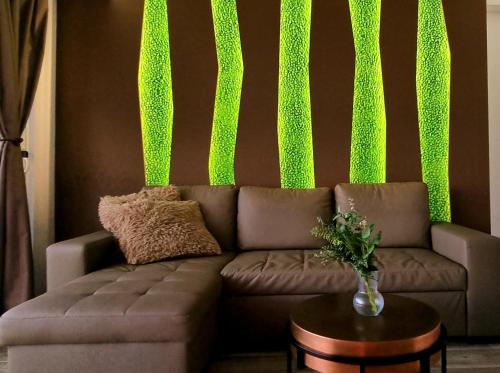 a living room with a couch with green lights at Hideaway Tenerife Holiday Apartment Las Américas in Playa Fañabe