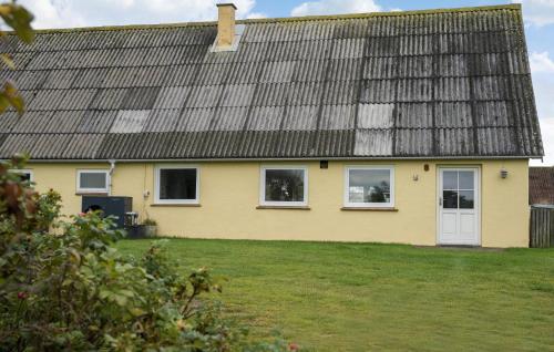 a yellow house with windows and a roof at Stunning Home In Ribe With Wi-Fi in Ribe