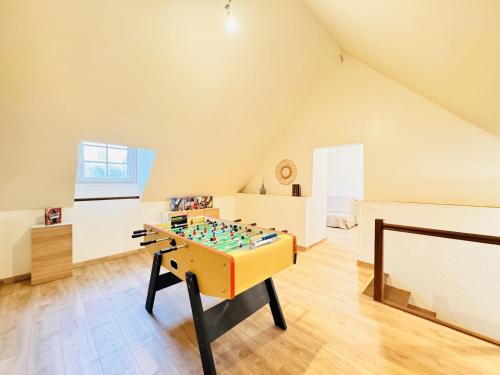 a room with a foosball table in a attic at Le Grand Bricoin - Campagne - Parking - 12 pers in Thorigné-sur-Dué