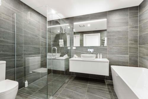a bathroom with a sink and a toilet at Penthouse with Marina Views - Studio or Two Bedroom Apartment in Wanaka