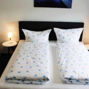 a bed with two pillows on top of it at Hotel Restaurant Harrier Hof in Brake