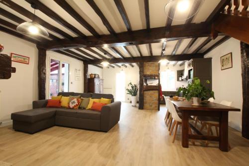 a living room with a couch and a table at Hego-aldea in Autevielle-Saint-Martin-Bideren