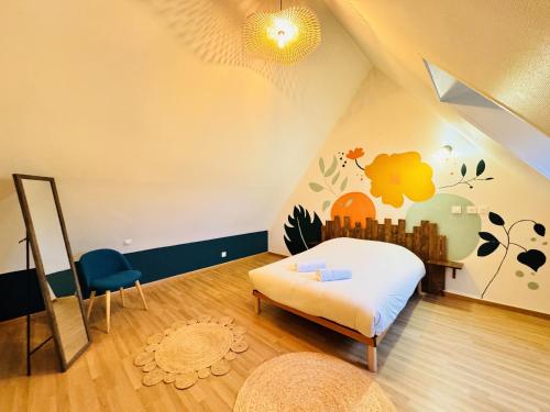 a bedroom with a bed and a chair in a room at Le Grand Bricoin - Campagne - Parking - 12 pers in Thorigné-sur-Dué