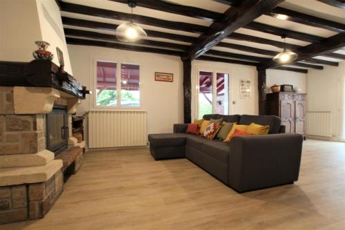 a living room with a couch and a fireplace at Hego-aldea in Autevielle-Saint-Martin-Bideren