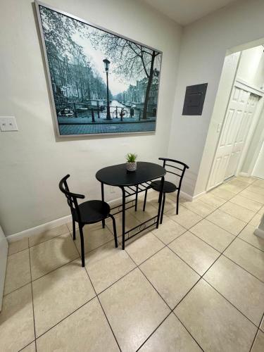 a table and chairs in a room with a picture on the wall at Apartment in Hollywood close to beach & shops 101 in Hollywood