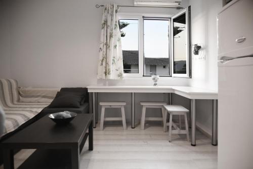 a kitchen and living room with a couch and a table at Spyridoula Resort in Corfu in Gouvia