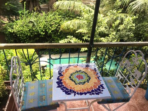 a quilt on a bench on a balcony at Fabuleuse Villa Keur Bibou in Dakar