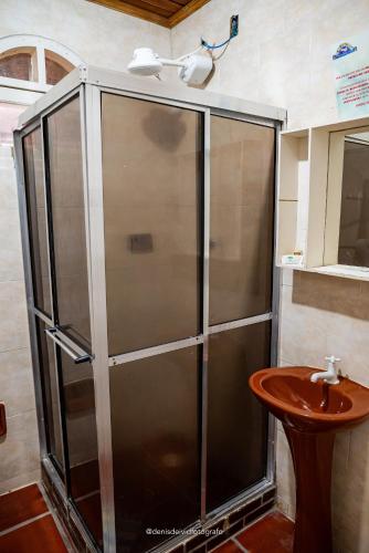 a shower in a bathroom with a sink at Pousada D'Aconchego Nova Brasilia in Ilha do Mel