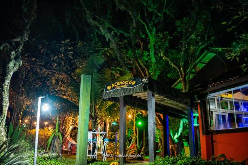 a sign in front of a restaurant at night at Pousada D'Aconchego Nova Brasilia in Ilha do Mel