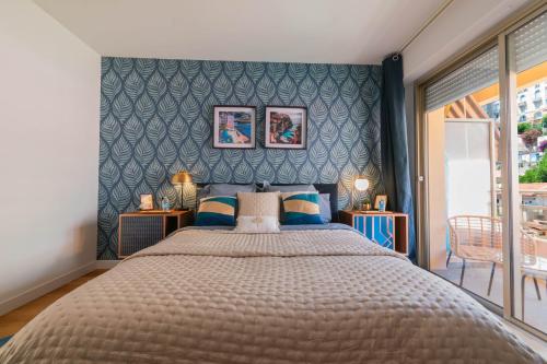 a bedroom with a large bed with blue walls at Luxury Monte Carlo- Seaview, Champagne & AC in Beausoleil