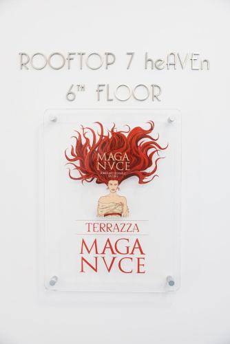 a sign for a magic floor with a picture of a woman with a fire at J Maluni City Hotel in Rome