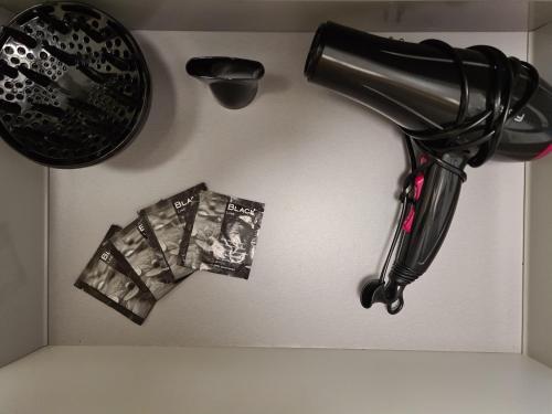 a hairdryer and a hair dryer hanging on a wall at Studio cosy et lumineux bike parking in Saverne