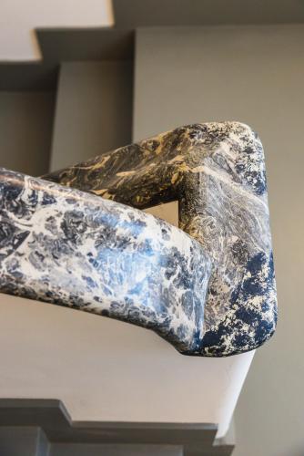 a sculpture of a stone on a wall at J Maluni City Hotel in Rome