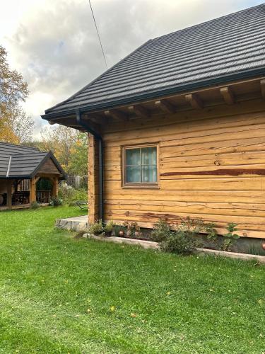 a log cabin with a window on the side of it at Fajna Chatka in Ustrzyki Dolne