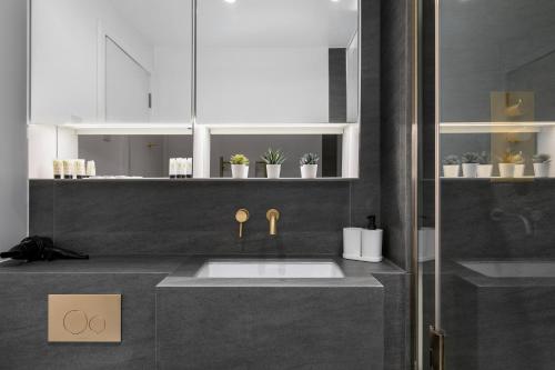 a bathroom with a sink and a counter at Kings Cross - Luxury 3 Bed Apartment, Private Balcony in London