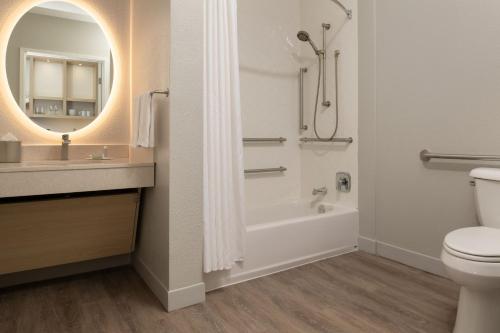 a bathroom with a tub and a toilet and a sink at TownePlace Suites San Jose Campbell in Campbell