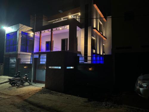 a building with a motorcycle parked in front of it at night at Villa ORMACE in Lomé