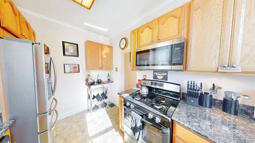 a kitchen with a stove and a refrigerator at ENTIRE Pittsburgh Home Close To Events - Kid Friendly - Designated Dog & Cat Areas - Private Patio - Free Parking - Fireplace in Pittsburgh