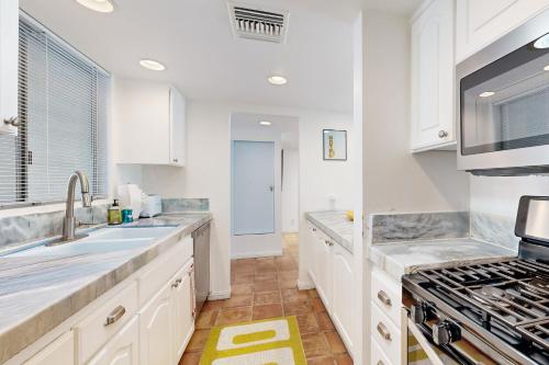 a white kitchen with a sink and a stove at The CoCo Cabana Unit 31 Permit# 4451 in Palm Springs