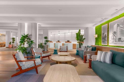a lobby with couches and chairs and a table at Hilton Aruba Caribbean Resort & Casino in Palm-Eagle Beach