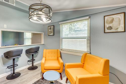 a waiting room with an orange chair and a table at Hike, Golf and Fish Pine Bluff Retreat in Pine Bluff