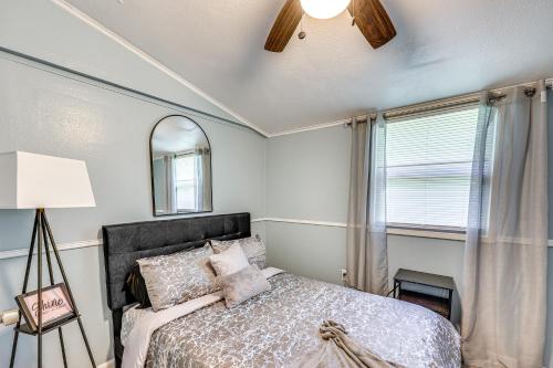 a bedroom with a bed and a ceiling fan at Hike, Golf and Fish Pine Bluff Retreat in Pine Bluff