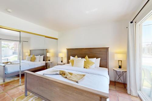 a bedroom with two beds and a large window at The CoCo Cabana Unit 31 Permit# 4451 in Palm Springs