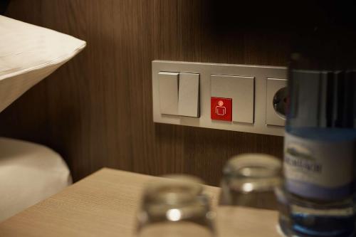 a bottle of water sitting on a table next to a lightswitch at bigBOX ALLGAEU Hotel in Kempten