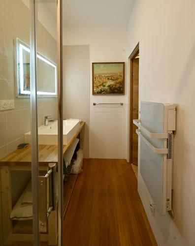 une salle de bain avec un lavabo et un réfrigérateur dans l'établissement Suite dans maison d'artiste, à LʼIsle-sur-la-Sorgue