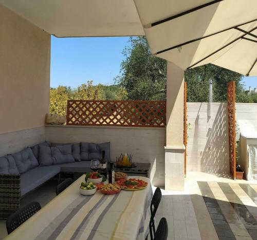 a patio with a table with food on it at Casa DOLCE PUGLIA Melograno in Castellana Grotte